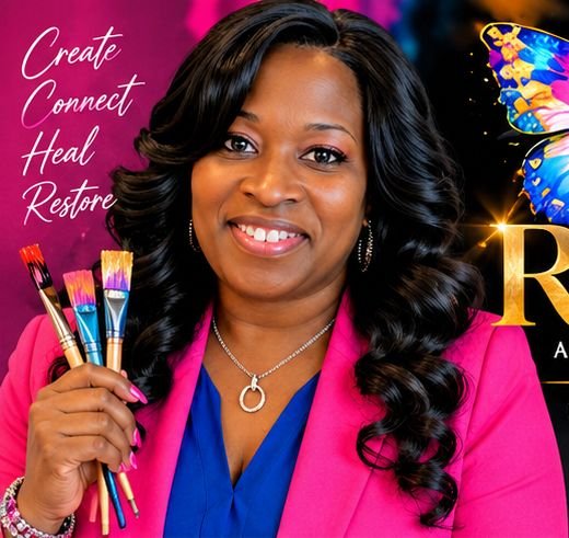 Coach KymmeB, host of Shades of Restoration, holding paintbrushes and smiling